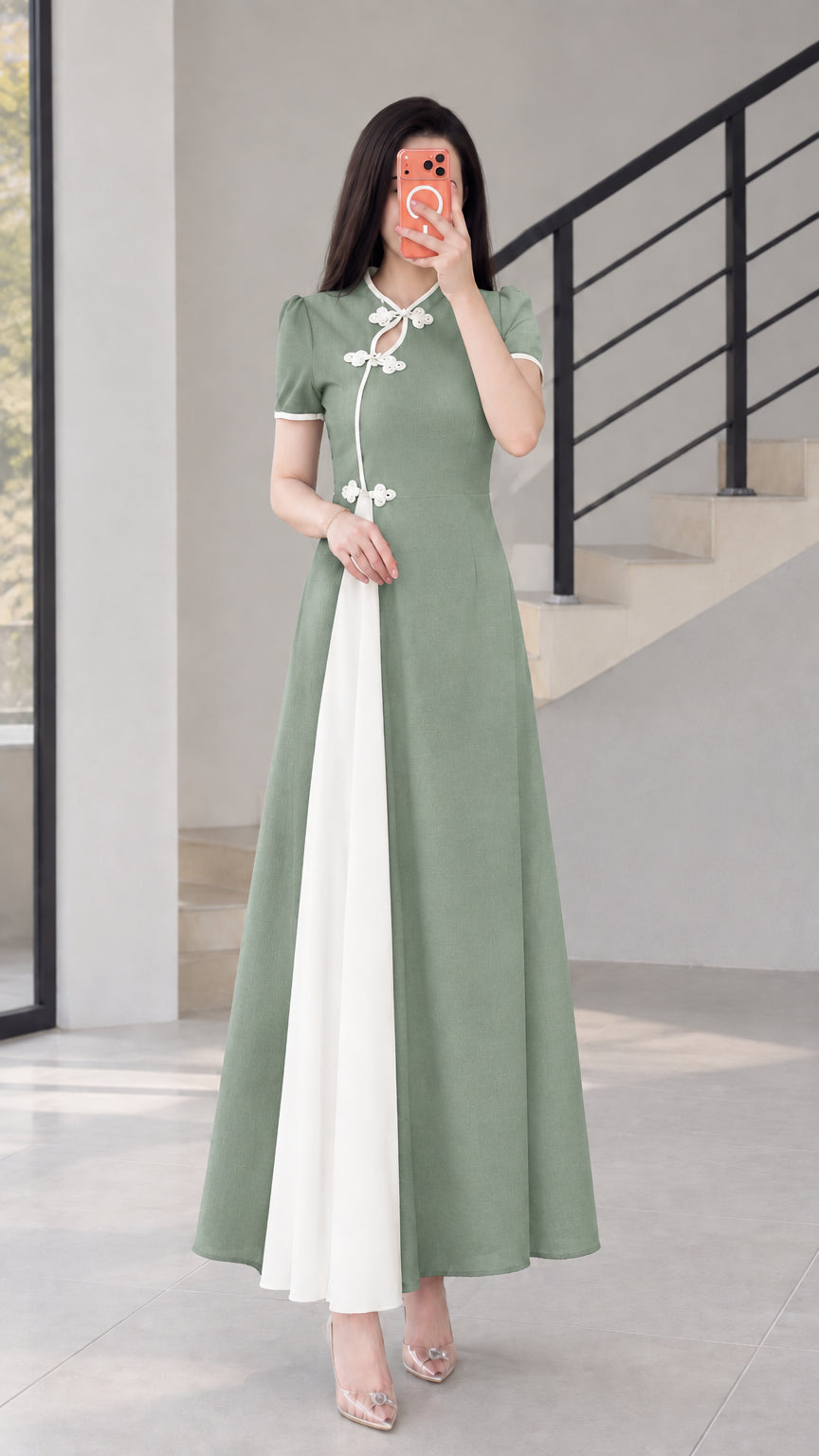 Front view of sage green modern cheongsam maxi dress with white contrast panel