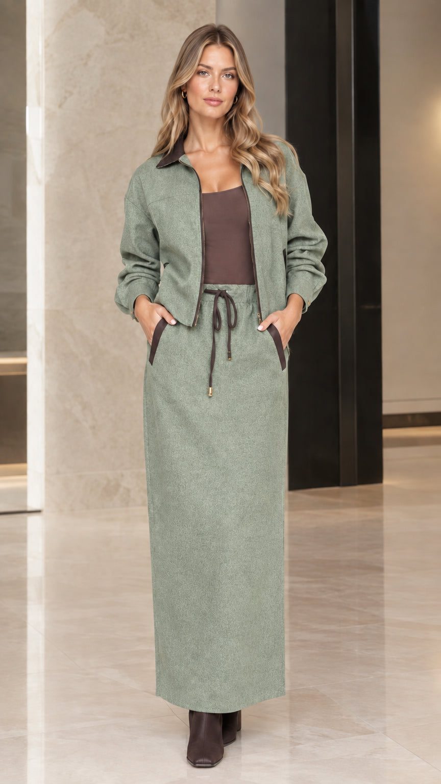 Model wearing Sage Green two-piece zip jacket and maxi skirt set
