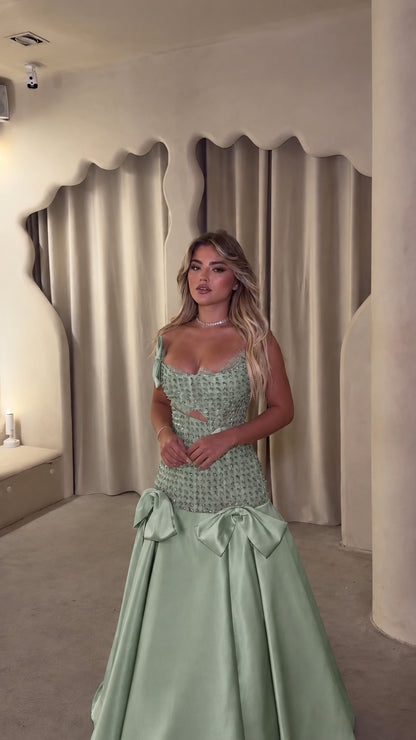Sage green crystal embellished drop-waist formal gown on model