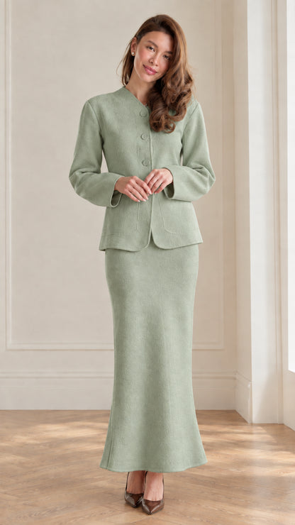 Full front view of women's sage green collarless jacket and maxi skirt suit set
