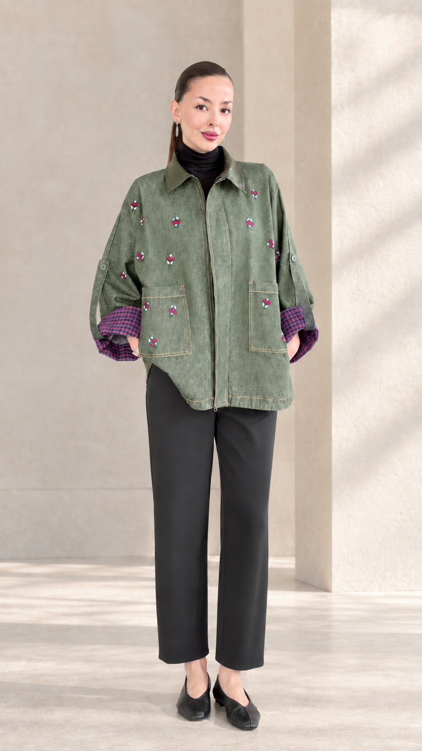 Sage Green embroidered zip-up jacket with front pockets on model