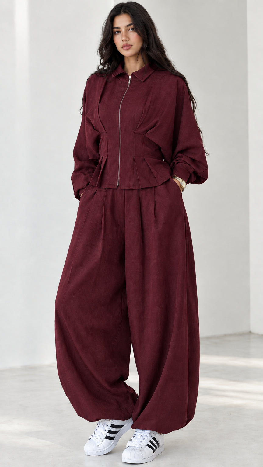 Model wearing burgundy wine red zip top and lantern trouser outfit