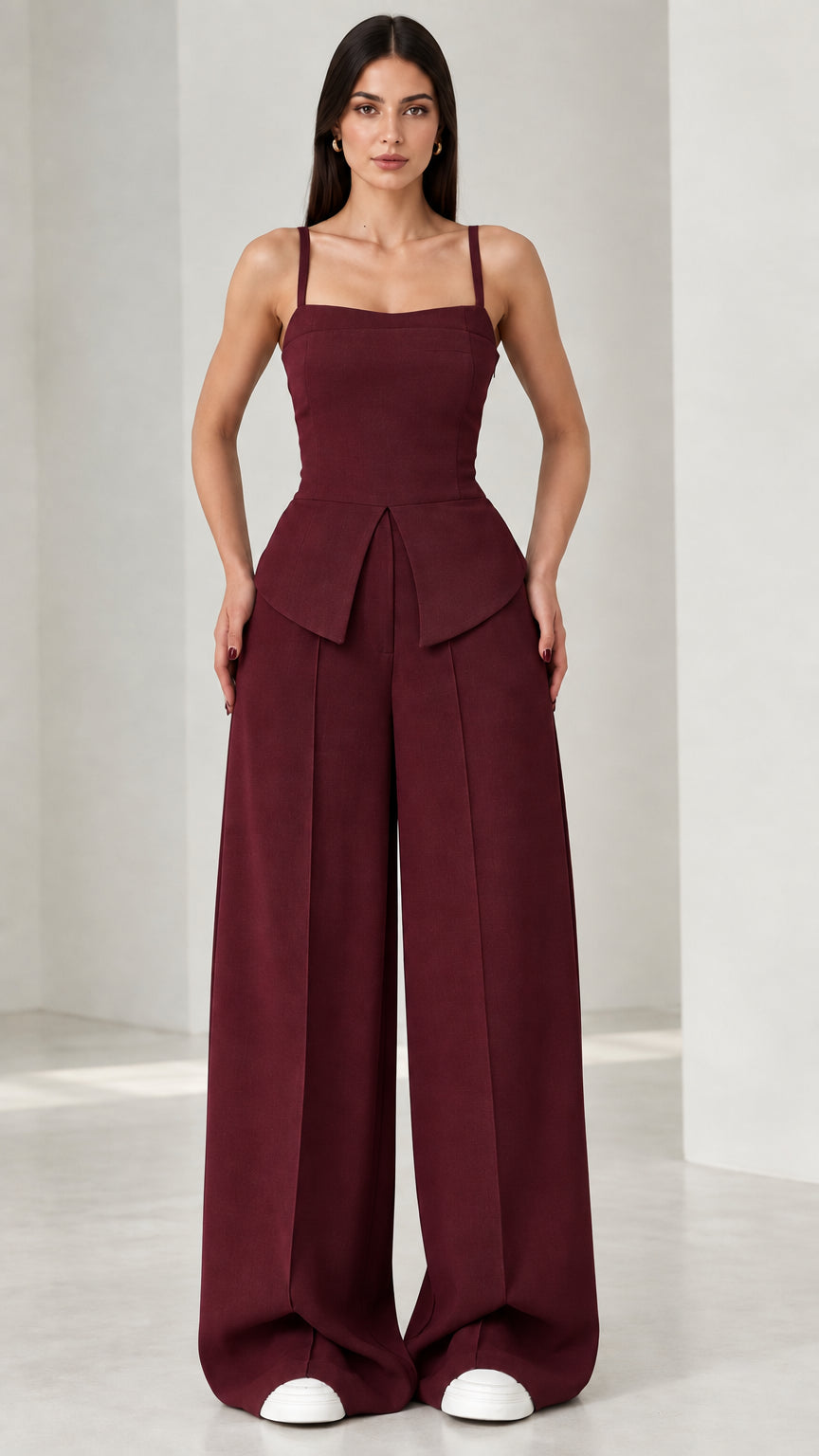 Full front view of model wearing burgundy square neck peplum wide leg jumpsuit
