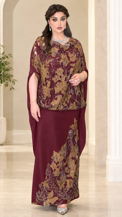 Model wearing burgundy red evening dress with floral lace cape