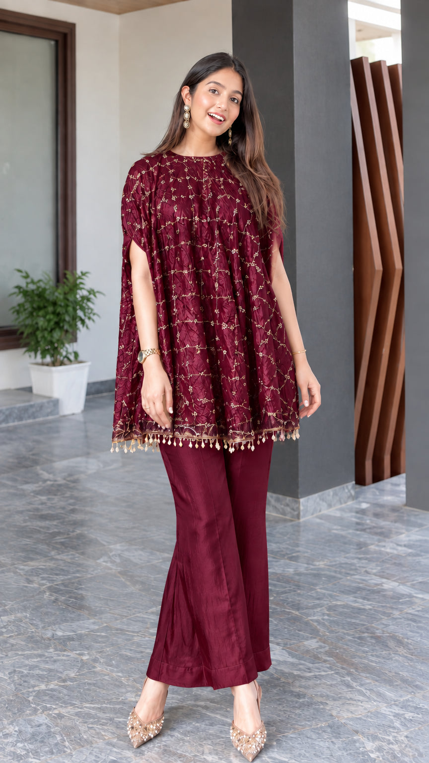 Model wearing maroon burgundy embroidered cape tunic and matching flared trousers