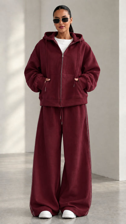 Model wearing Burgundy red zip-up hoodie and matching wide-leg track pants set