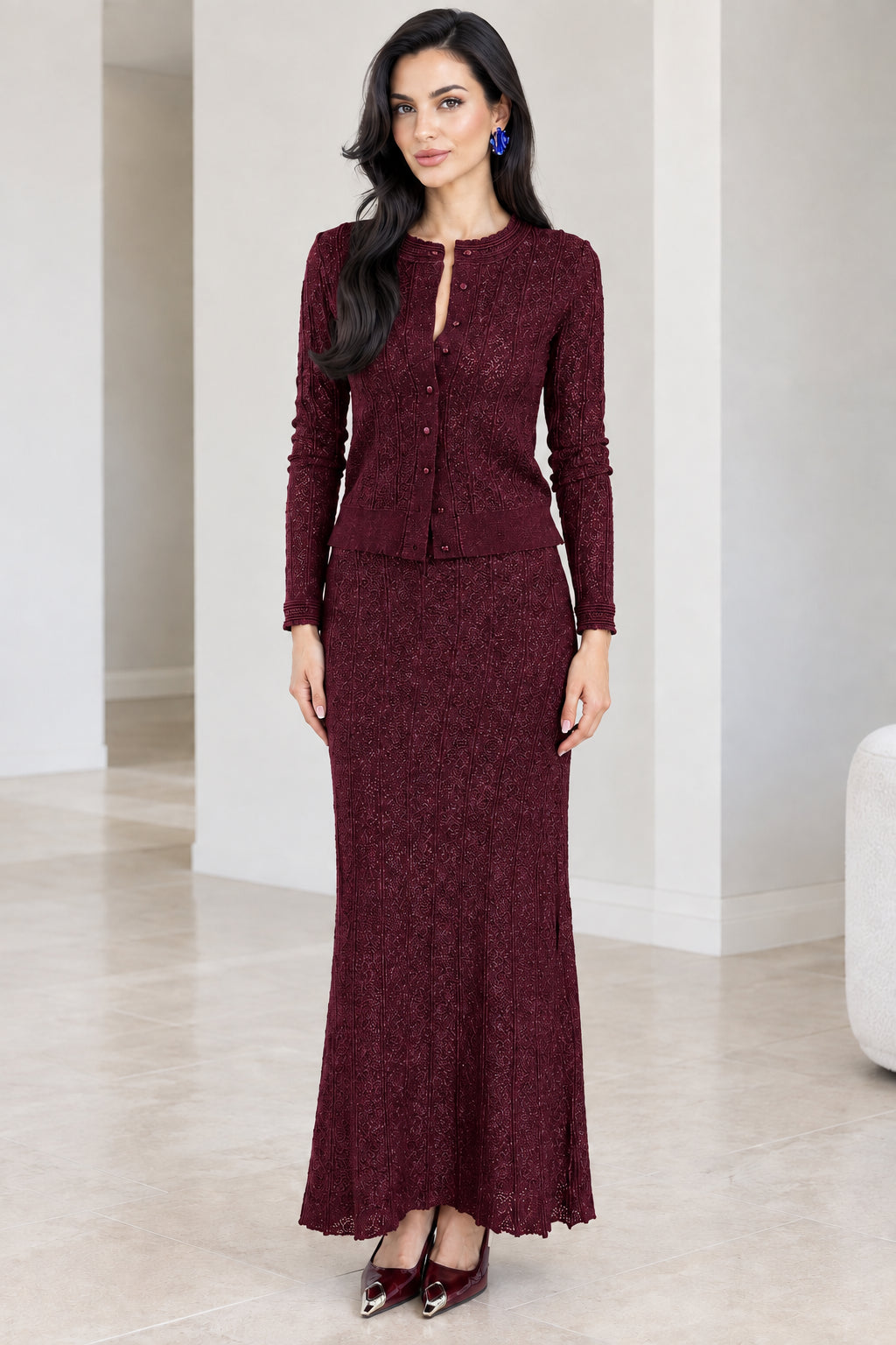 Front full-length view of burgundy red textured knit cardigan and maxi skirt set