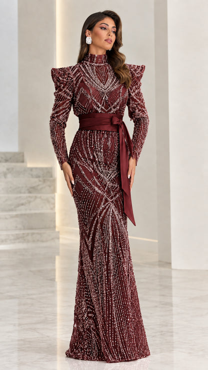 Model wearing burgundy wine red embellished formal dress with structured shoulders