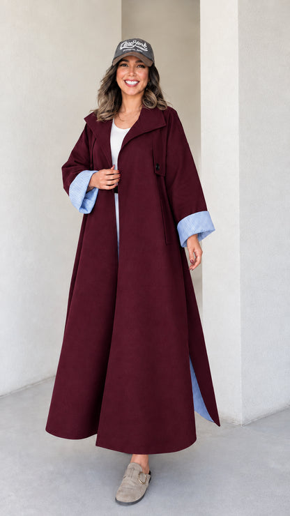 Full-length studio shot of woman wearing burgundy wine red maxi trench duster coat