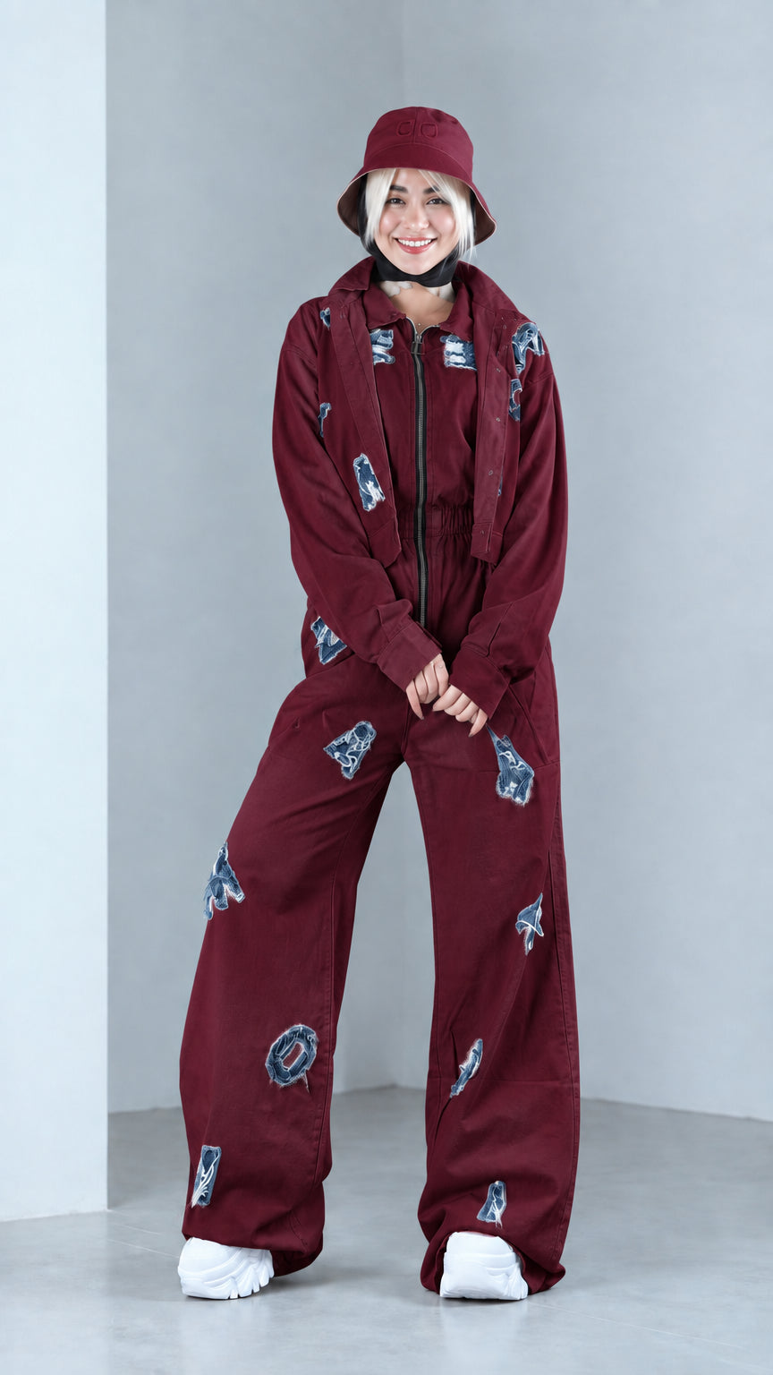 Full front view of model in burgundy distressed two-piece jacket and pants set