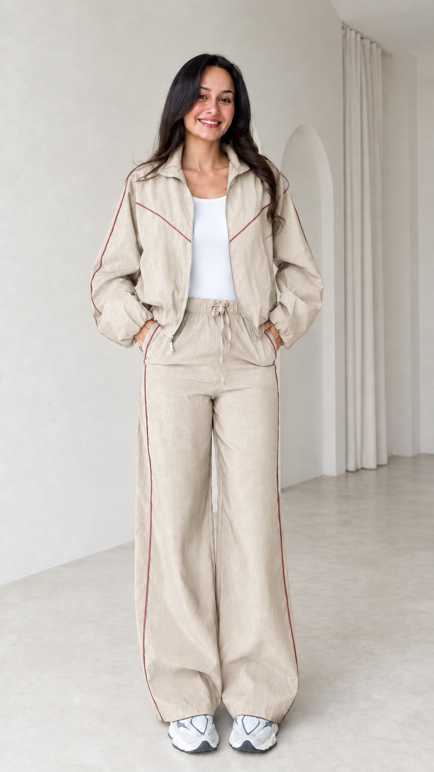 Model wearing beige zip track jacket and wide leg pants set