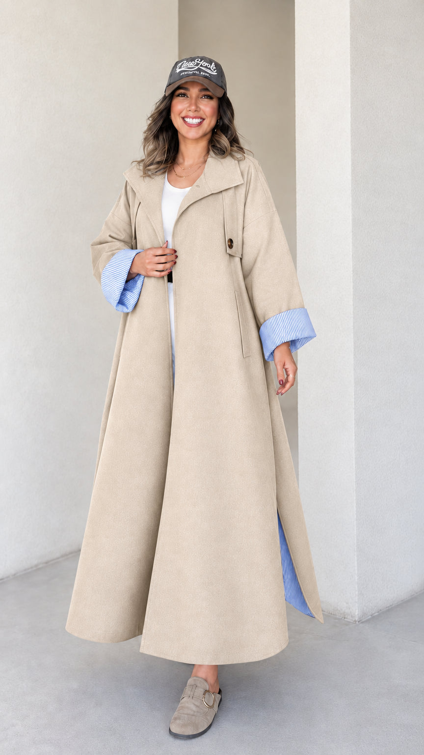 Full-length studio shot of woman wearing beige khaki maxi trench duster coat