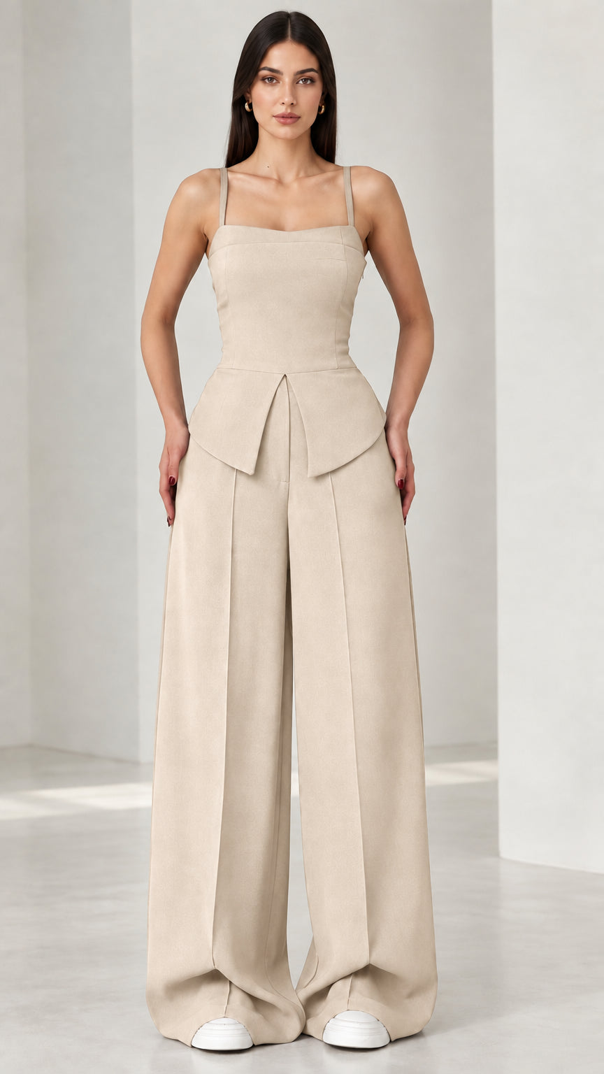 Full front view of model wearing beige square neck peplum wide leg jumpsuit