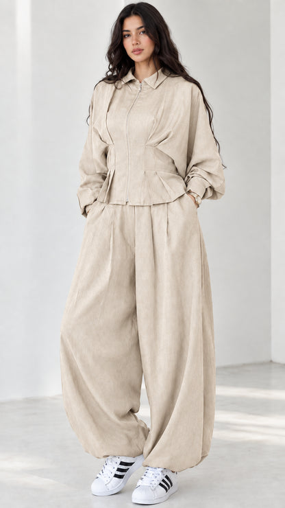 Model wearing beige cream collared zip-front jacket and balloon pants set