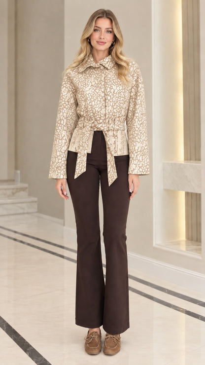 Front view of model wearing cream beige textured jacquard belted jacket