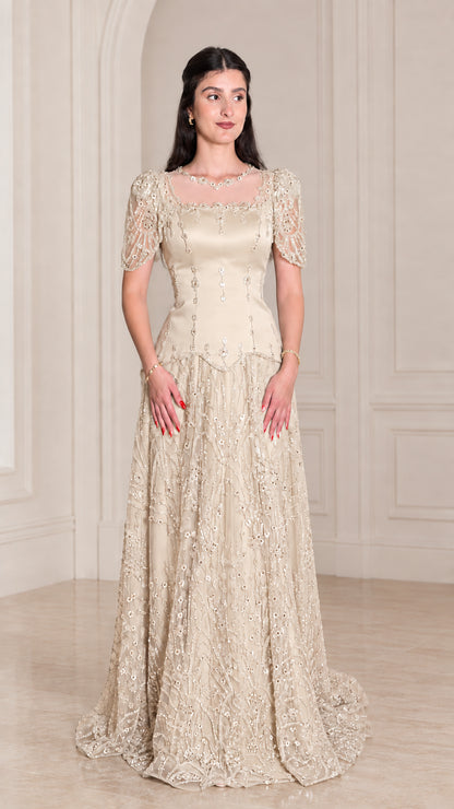 Model wearing Champagne gold embroidered formal evening gown