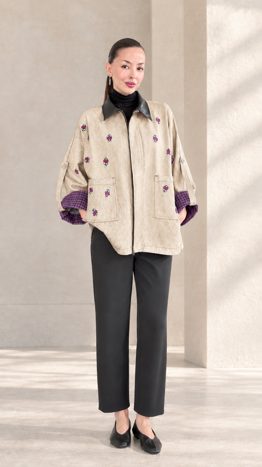 Beige neutral embroidered zip-up jacket styled with black trousers