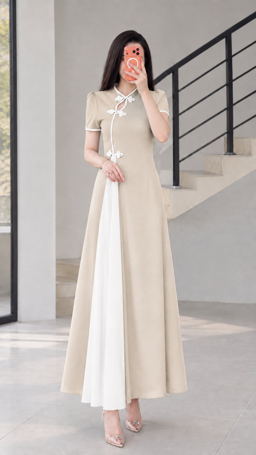 Front view of beige modern cheongsam maxi dress with white contrast panel