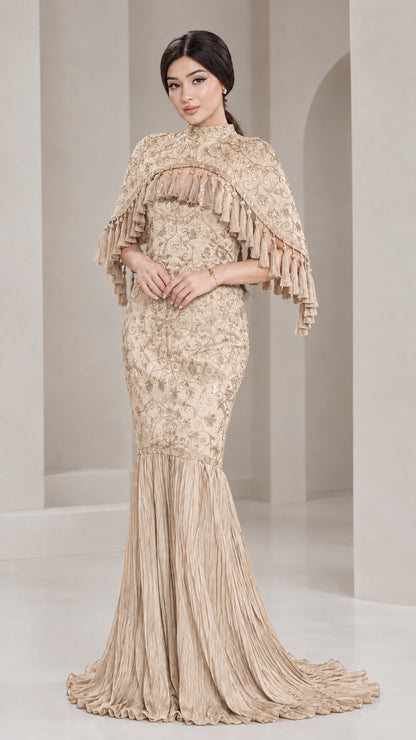 Front view of model wearing Champagne gold sequin cape mermaid evening gown
