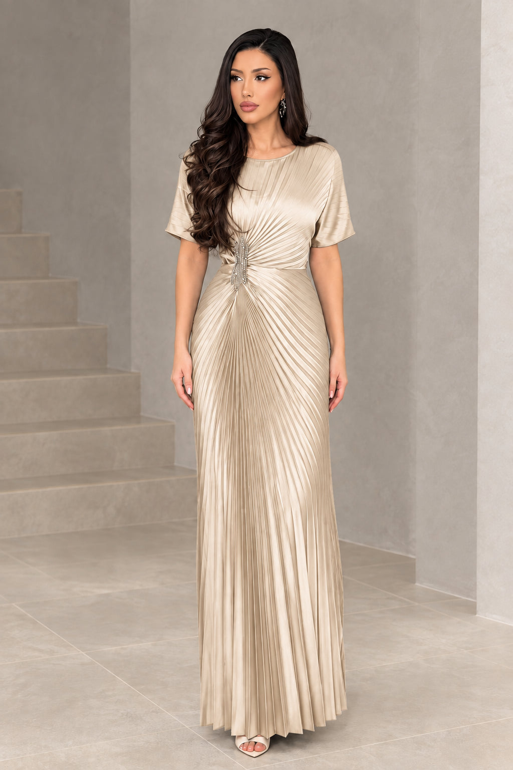 Front full-length view of woman wearing champagne gold pleated evening dress
